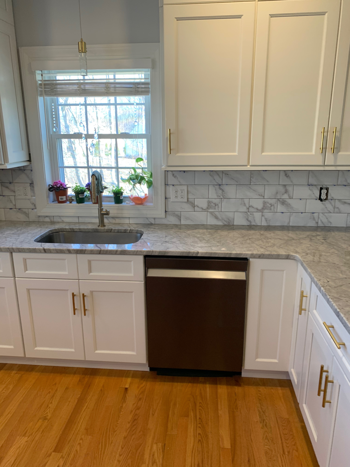 Completed kitchen remodel with installed backsplash and finished cabinetry