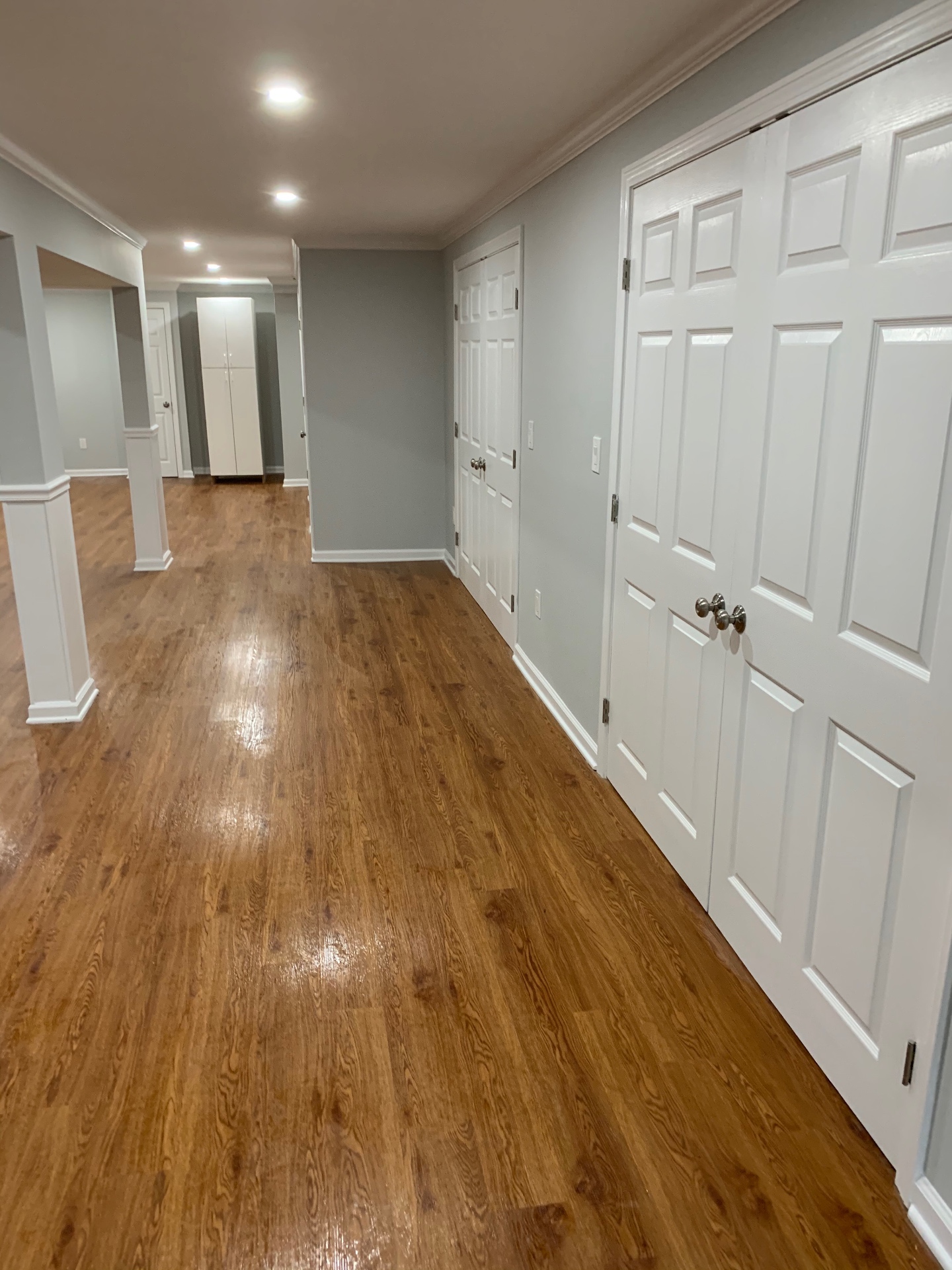 Finished lower level with wood flooring, recessed lighting, and clean trim details